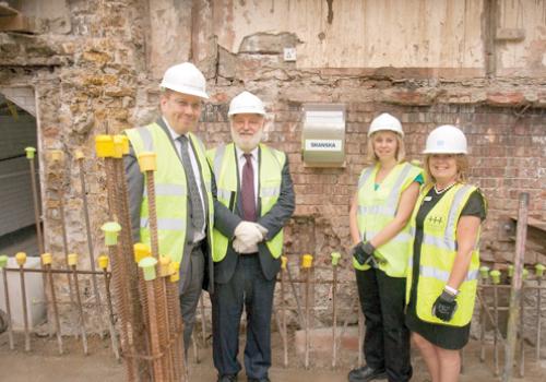 Sir Robert Naylor and MP Frank Dobson bury the time capsule at UCLH