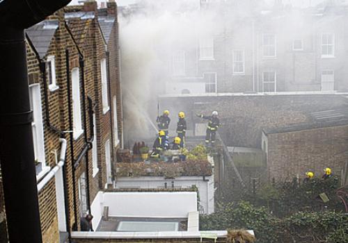 Fireman work to bring the blaze at the house in Coleman Fields under control 