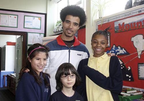 Akala with pupils at Ashmount primary school on Tuesday