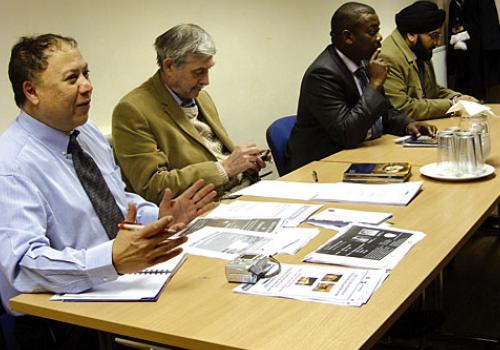 Chairman Talal Karim, left, with fellow speakers