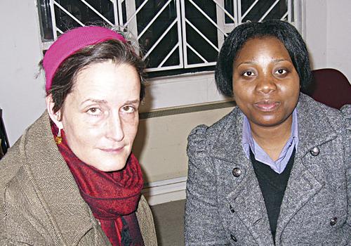 Barb Jacobson, left, with resident Alice Oyane at Charles Rowan House