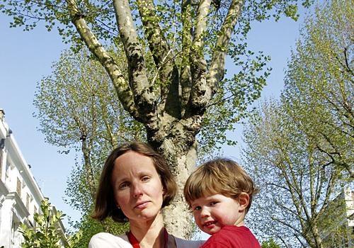 Resident Christiane Comins, with son Teddy, in front of one of the trees  