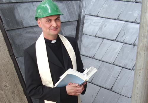 Father Shaun Richards blesses new solar panels 