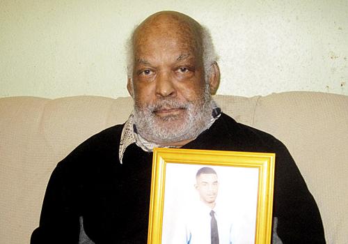 Grieving Bob Jaipaul with a picture of his stabbing victim son, Andrew