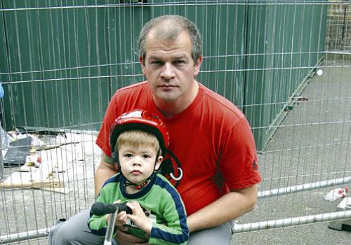 Cllr Arthur Graves and son Nick, 3, in playground taken over by builders