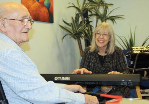 Harriet Powell with Bill Lawson during a music therapy session at Ingestre Road