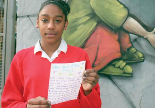 Asha Solanki outside ‘The Winch’ with a copy of her letter