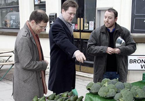 Lib Dem PPC Ed Fordham and leader Nick Clegg buy fruit from a trader