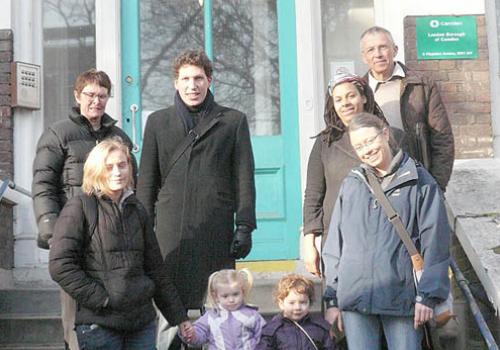 Belsize Park Lib Dem councillor Tom Simon, centre, outside the proposed free sch