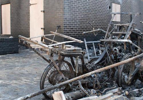 The fire-damaged motorbikes near  Tops Pizza