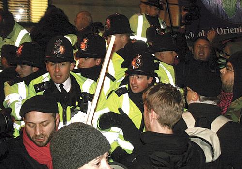 Police and protesters clash outside Camden Town Hall after the doors were locked