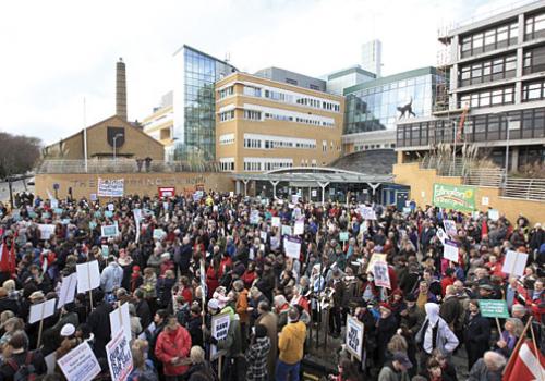 The rally gathers to hear speakers outside the Whittington hospital