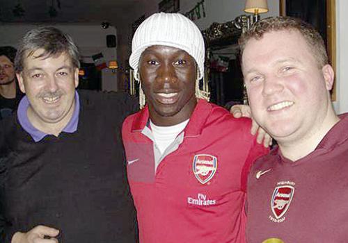 Pub landlord Pat Logue with Bacary Sagna and Gunners fan John Mahon