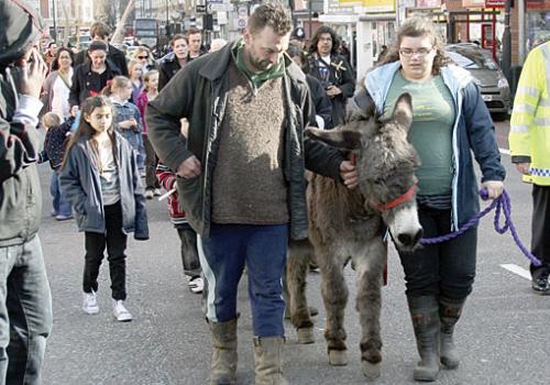 Larry the donkey heads Palm Sunday procession along Camden High Street