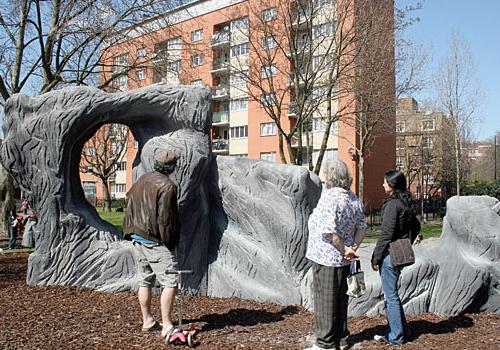 Parents assess the new rock playground before letting their children use it