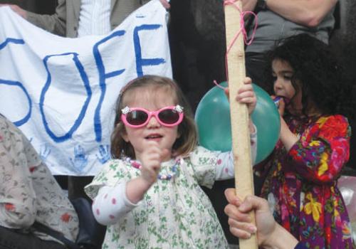 Two-year-old Jessica Lawrence holding a placard at the demonstration.