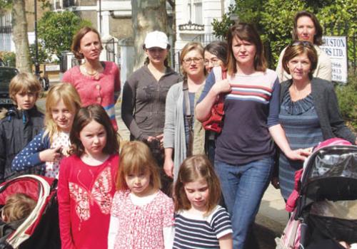 Campaigners gather around the trees threatened with the axe in Richmond Avenue