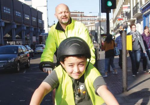 Lochlann cycles through the capital, accompanied by his father, Cornelius 