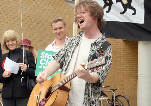 Dave Plummer sings his Whittington protest song outside the hospital