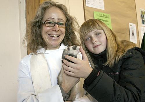 Reverend Philippa Turner with Maya Barach, 11, and her ferret, Fluffy