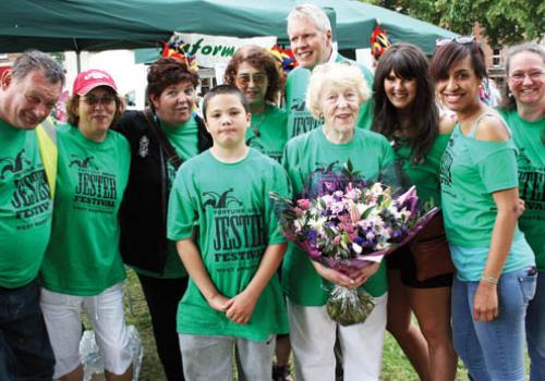 Cllr Flick Rea receives flowers from grateful organisers and volunteers