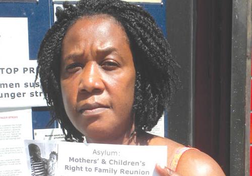 Jeto Flaviaih with petition. ‘My children are living with a stranger,’ she says