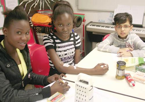 Sisters Christina, 16, and Ajak Pare, 14, with Khalid Albaloushi, 12, in the hos