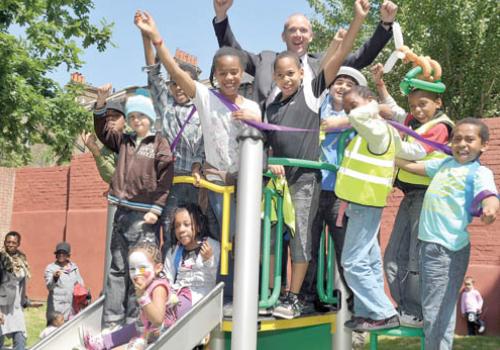 Darren Levy of CityWest Homes opens the new Mozart playground with children from