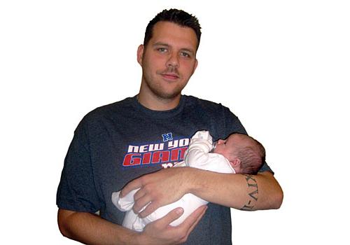 Kentish Town firefighter Paul Chilton with his new baby son Joseph