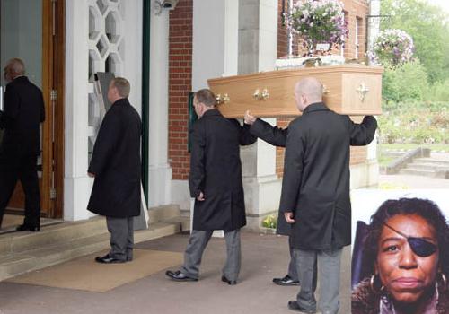 The body of Jennyfer Spencer, inset, is carried into the crematorium.