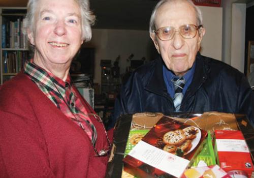 Beryl and John Dewing take delivery of their hamper