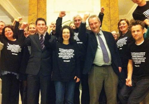 Objectors to the demolition celebrate after the committee meeting.