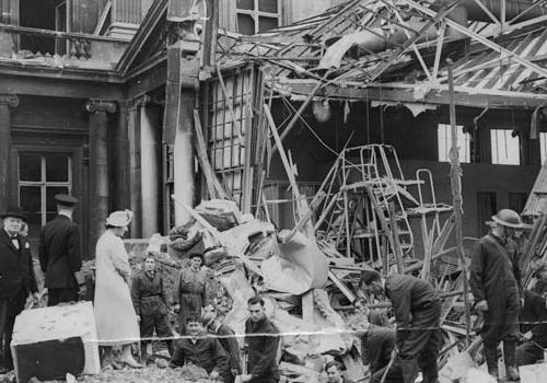 Churchill surveys  the damage with the King and Queen 