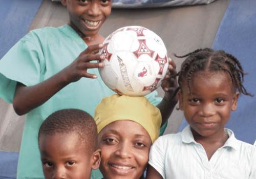 Taka Dzuda is pictured with Guillame, top, and other orphaned children